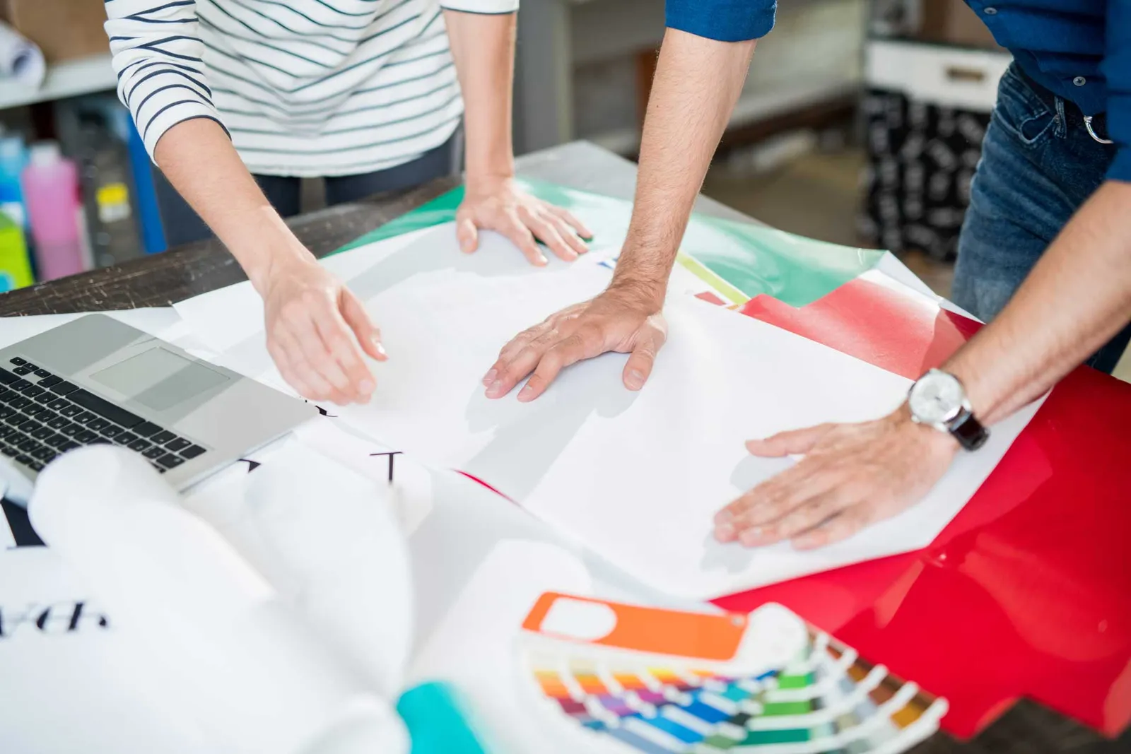 colleagues of printing house touching paper